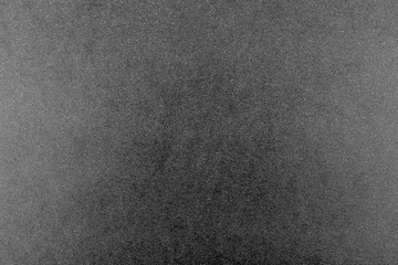 Fototapeta premium Black and white background made of real black paper with white dots, illuminated by a soft light on the sides.