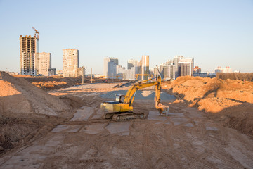 Excavator and vibration single-cylinder road roller at the construction of road and foundation....