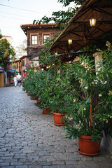 Cobblestone and stone-tiled streets of the old tourist part of the city of Bulgaria. Typical Bulgarian houses made of stone and wood in old Sozopol, Nessebar, Veliko Tarnovo