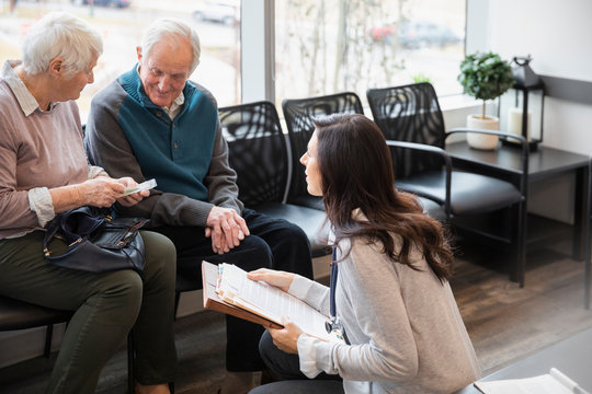 Senior Couple Discussing Paperwork With Medical Consultant