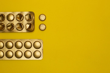 blister packs and medicine pills on yellow background - 327927945