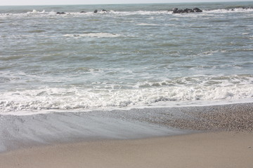 A winter beach with rough seas with cold and dull colors in the Versilian Riviera