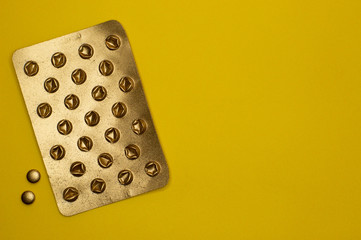 empty blister pack and little pills on yellow background - 327928588