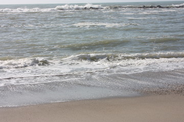 A winter beach with rough seas with cold and dull colors in the Versilian Riviera
