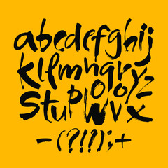 Vector Acrylic Brush Style Hand Drawn Alphabet Font. Calligraphy alphabet on a yellow background. Ink hand lettering.