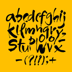 Vector Acrylic Brush Style Hand Drawn Alphabet Font. Calligraphy alphabet on a yellow background