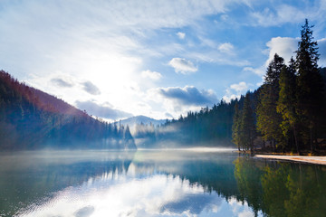 Fototapeta na wymiar Small lake among mountain forest