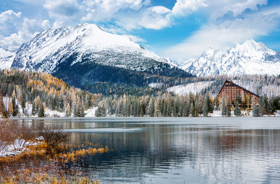 Beautiful scenery of the Strbske Pleso lake in winter with a nice cloudscape and the snowy peaks of High Tatras mountain in Slovakia