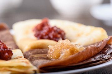 Selective focus. Pancake with apple Jam. Pancakes are ordinary and with the addition of cocoa in the dough.