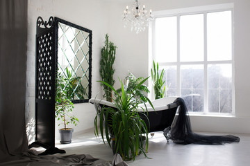 Exclusive modern black and white bathroom interior in luxury mansion with big window