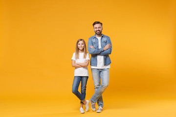 Fototapeta na wymiar Smiling bearded man in casual clothes have fun with cute child baby girl. Father little kid daughter isolated on yellow background. Love family parenthood childhood concept. Holding hands crossed.