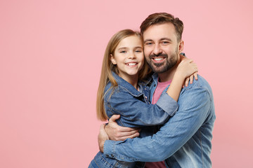 Pretty bearded man in casual clothes have fun with cute child baby girl. Father little kid daughter isolated on pastel pink background in studio. Love family parenthood childhood concept. Hugging.