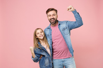 Happy bearded man in casual clothes have fun with cute child baby girl. Father little kid daughter isolated on pastel pink background. Love family parenthood childhood concept. Doing winner gesture.