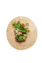 Arabic or Mexican bread with meat, vegetables and lettuce. Round tortilla on a light background. Closeup. Top view. Copy space