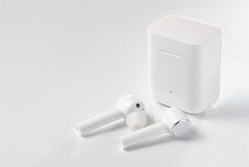  White Wireless Sport Headphones with Charging Box. Wireless in-ear Headphones for Jogging. Close...