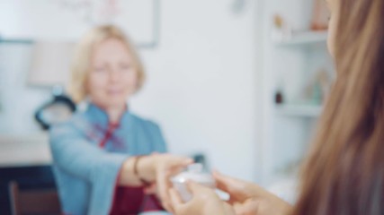 A woman passes a cup of tea. Tea ceremony