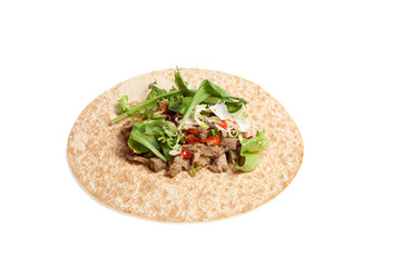 Arabic or Mexican thin bread with meat and vegetables. Round tortilla on a light background. Closeup. Copy space
