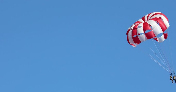 Two Young Women Parasailing In The Blue Sky At Sunny Beach In Bulgaria, Black Sea, Europe - DCi 4K Video