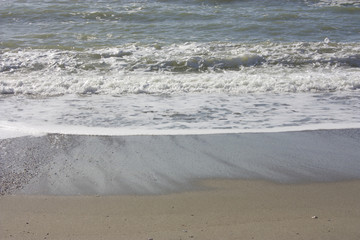 A winter beach with rough seas with cold and dull colors in the Versilian Riviera