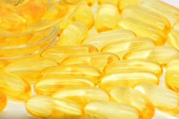 Fish oil capsules with omega 3 and vitamin D, healthy eating concept