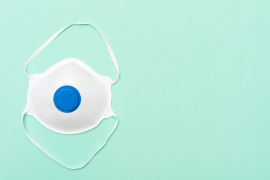 Mask on green background. Coronavirus or Covid-19 virus concept