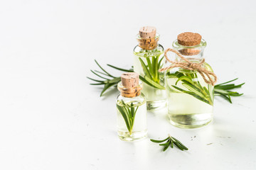 Obraz na płótnie Canvas Rosemary essential oil in the bottle on white.