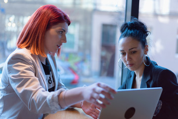 Startup Diversity Teamwork Brainstorming Meeting Concept.Two Business Coworkers Sharing World Economy Report Document Laptop.People Working Planning Start Up.Young Hipsters Discussing Cafe