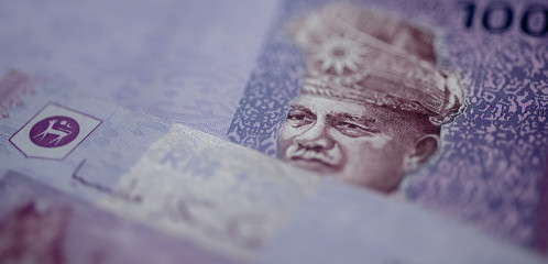 Malaysia currency of Malaysian ringgit banknotes background. Paper money of hundred ringgit notes etreme closeup. Financial concept.