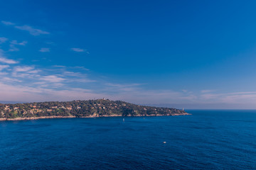 Fototapeta na wymiar The panoramic view of Saint-Jean-Cap-Ferrat and the Mediterranean Sea's turquoise water during sunset (Provence Côte d'Azur, France)