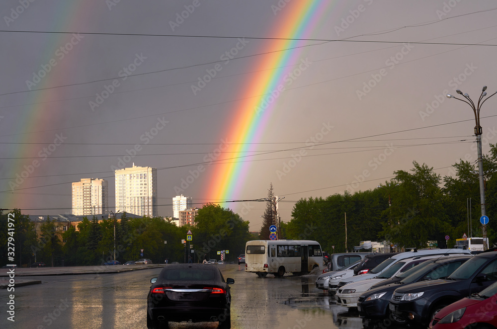 Wall mural rainbow in the city during the rain