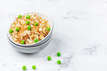 Turkish national recipe, rice pilaf with fried noodles. A delicious side dish with green peas. Copy space.