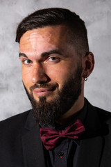 Confident elegant man looking at camera at studio