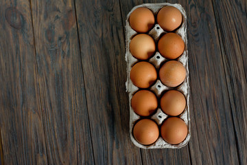Fresh Chicken brown eggs in carton box on wooden table. organic farming concept. Natural healthy food.