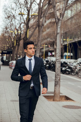 young boy walking with blue suit in city