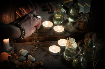 Hand of fortuneteller with a magic symbol during spiritual session