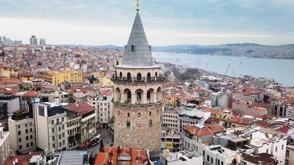 Aerial zoom in. Historical Galata Tower one of the oldest towers in the world, build by Byzantium Emperor Anastasius in 507. Tracking shot