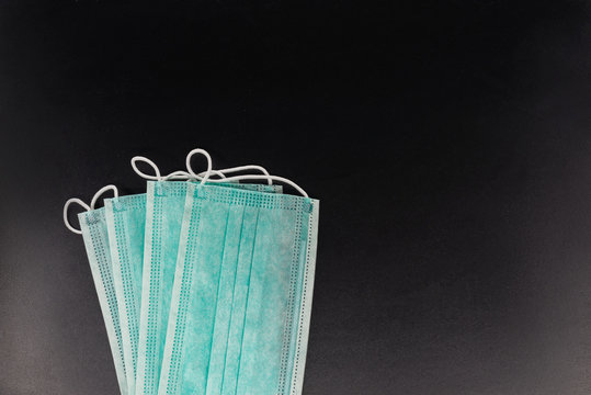 Surgical mask with rubber ear straps. Typical 3-ply surgical mask to cover the mouth and nose. Procedure mask from bacteria. Protection concept.