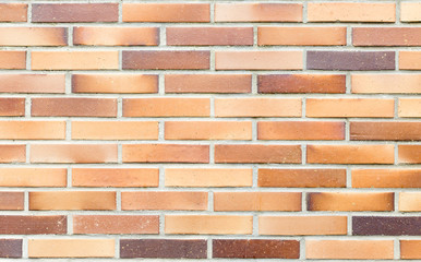 Fototapeta premium wall made of ceramic bricks with different shades of brown and ochre, for bottom or resource of building materials