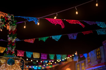 Mayan Riviera, Mexico - Nov 2019 "Papel picado" is a decorative craft made by cutting elaborate designs into sheets of tissue paper, common themes include birds, floral designs, and skeletons