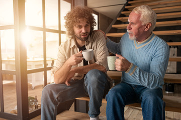 Father and son drink a coffee together. Concept of family relationship - Powered by Adobe