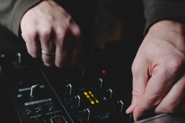 hand of dj on sound mixer