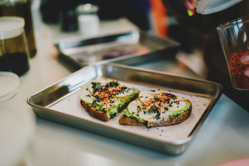 Open sandwich with pumpkin and chia seeds, avocado and pear slices on a multigrain rye bread. Delicious vegetarian food made from natural gluten free ingredients. Healthy and tasty meals for breakfast