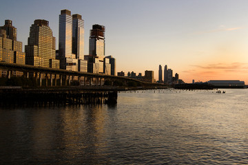 Hudson River with skyscrapers at sunset in New York City