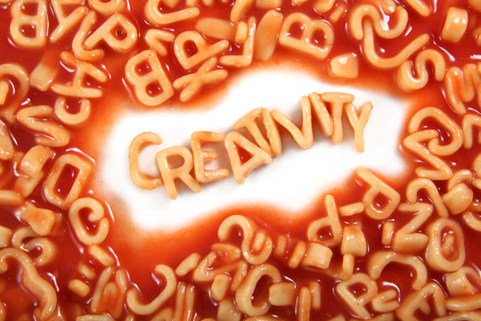 Creativity written in spaghetti pasta letters surrounded with jumbled letters.