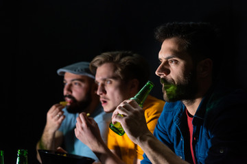 Group of friends watching sport game at home, cheering