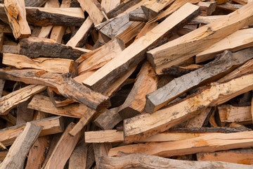 Wooden background. Firewood stack for the background. A lot of cutted logs. Stack of sawn logs. Natural wooden decor background. Pile of chopped fire wood prepared for winter.