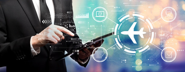 Flight ticket booking concept with businessman using his tablet computer