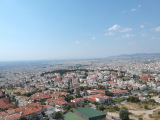 Fototapeta na wymiar Aerial drone shot over the city of Thessaloniki revealing a medieval castle and the city in Sykies
