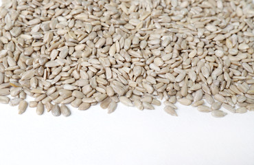 peeled sunflower seeds on white background close up