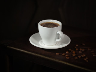 cup of black coffee and coffee beans